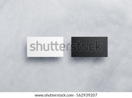Two blank business card mockups isolated on grey textured background. Black and white namecard design mock up presentation. Empty horizontal visiting paper sheets template with shadows.