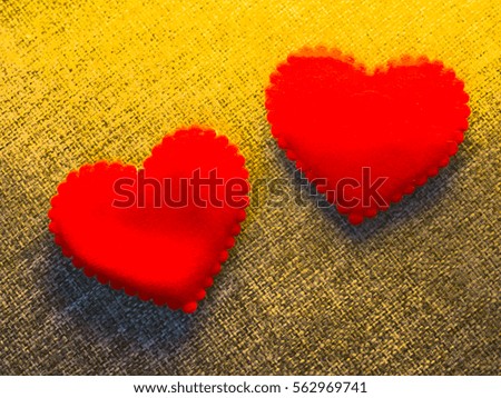 Valentine card heart shaped from old red paperr hanging on a clothesline on a linen background