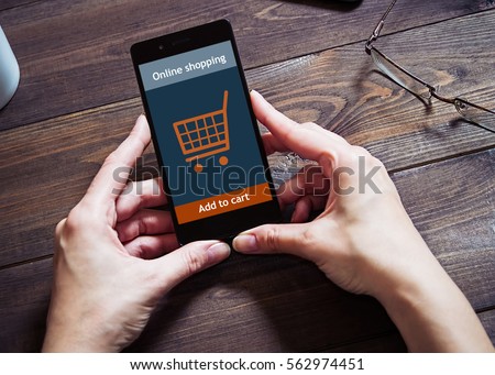 A woman is shopping at the online store. Shopping cart icon. Ecommerce. Royalty-Free Stock Photo #562974451