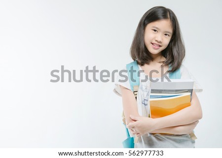 Young Asian student girl holding books on isolated background