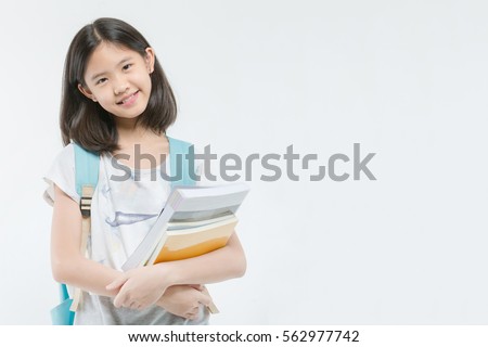 Young Asian student girl holding books on isolated background Royalty-Free Stock Photo #562977742