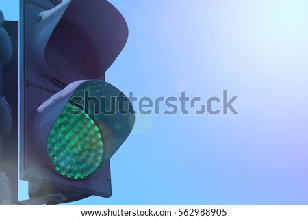 Green traffic light on a background of beautiful blue sky