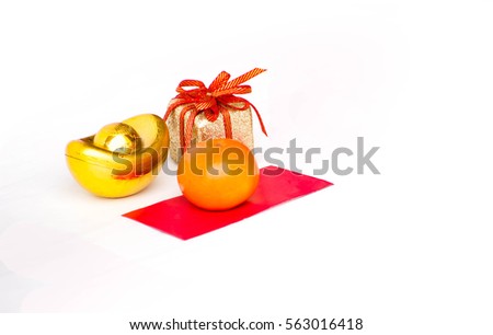 Chinese New year,red envelope packet (ang pow) with gold ingots and oranges on brown wood table top,Chinese Language mean Happiness