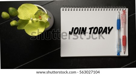 Office desk with a word JOIN TODAY on notebook page. View from above