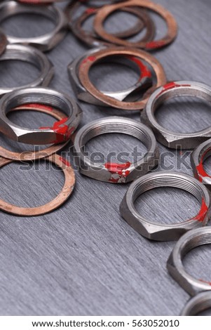 Nuts and washers on metal background