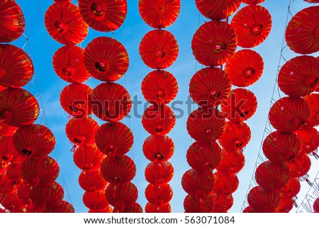Chinese red lanterns hanging at street for decoration during the Chinese New Year festival at Chinatown, Ratchaburi, Thailand 
Red lamps decoration with blue sky