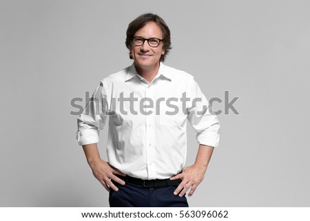 Confident mature man on grey background