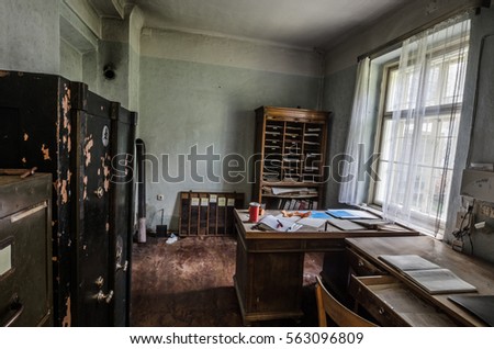 abandoned old office with furniture Royalty-Free Stock Photo #563096809