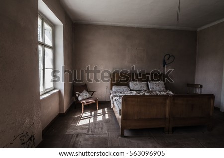 abandoned bedroom with furniture Royalty-Free Stock Photo #563096905