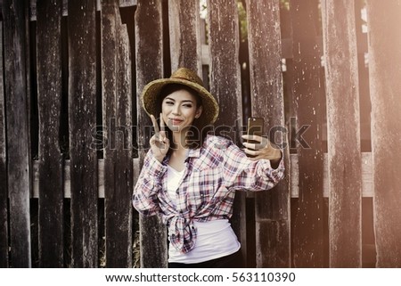 Asian woman play mobile.