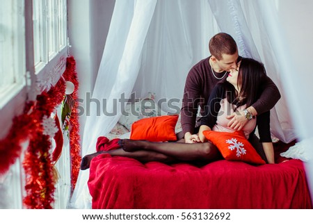 Picture of young couple kissing in bed