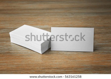 Stack of blank business cards on wooden background