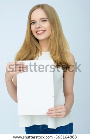 Advertising. Young smiling woman show blank card or paper on white background.