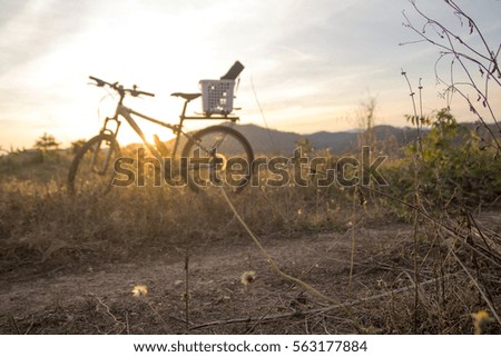 Evening recreation with bicycle with sunset and dramatic sky