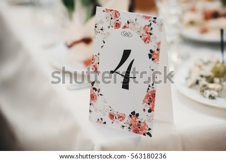 The paper with number stands on the table Royalty-Free Stock Photo #563180236