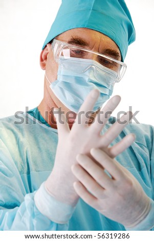 Close-up of surgeon?s hand wearing sterile glove over white background