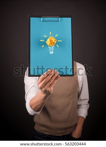 Business man holding a clipboard with an idea symbol of crumpled paper