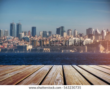 panorama of modern city upon water, Istanbul, wooden pier in foreground