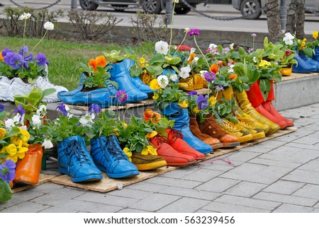 Colorful old boots used as flower pots