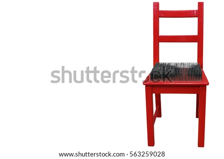 red chair with spikes on the seat Royalty-Free Stock Photo #563259028