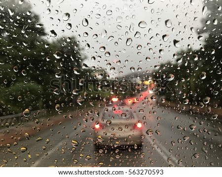 Raining day trough the car windows in malaysia road during monsoon