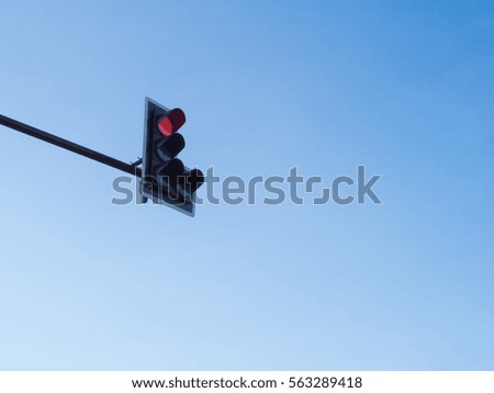 Traffic light red with blue sky background