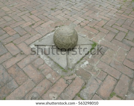 stone street ball-shaped bollard 
