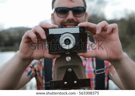 beard man with retro camera in the park 