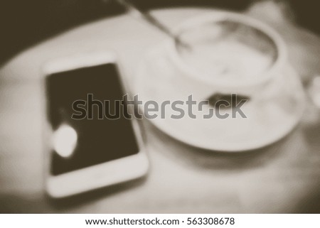 Picture blurred  for background abstract and can be illustration to article of Phone and coffee in cafe