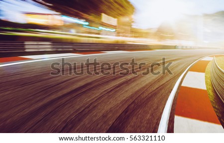 Motion blurred racetrack,sunset scene Royalty-Free Stock Photo #563321110