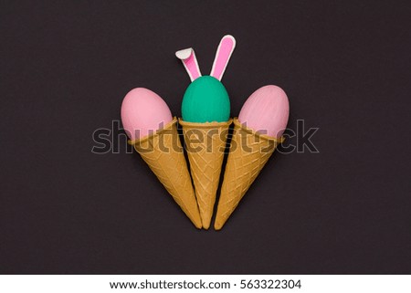 Easter eggs in waffle cones on a black background. flat lay. Easter holiday concept background