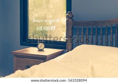 Good Monday text wrote on rain drop window and alarm clock,retro filter in white bedroom,retro filter