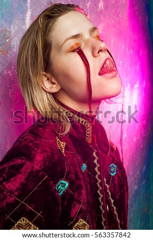 Fashion colorful photos in photo studio with colorful lights. Beautiful girl is posing, dynamic compositions, emotional model.