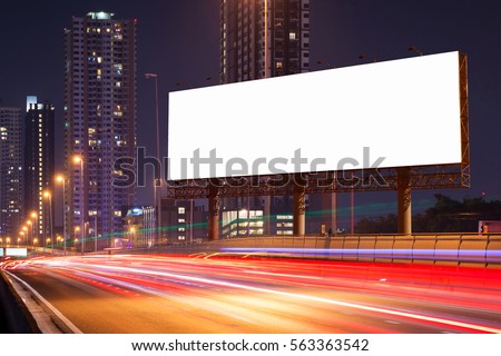 White Blank billboard on light trails, street, city and urban in the dusk or night- can advertisement for display or montage product or business. Royalty-Free Stock Photo #563363542