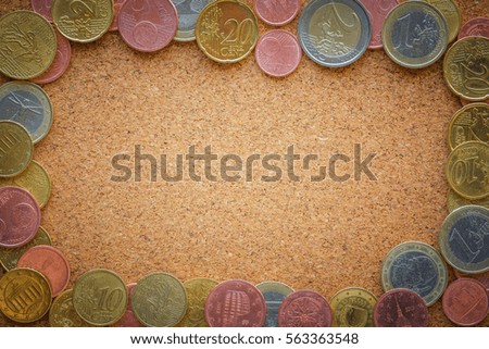 Top view Euro coins on cork board as business, money, banking, currency concept - can input center text