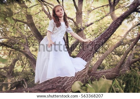 girl in fairy tale park with tree in spring