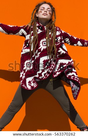 Colorful fashion photos on orange background with chocolate. Dynamic brighter pictures with beautiful girl.