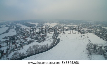 Winter landscape, the bridge and the river are filmed from the height of bird flight