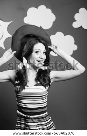 Black and white portrait of amazed excited young woman actress on the theatrical play handmade sky background