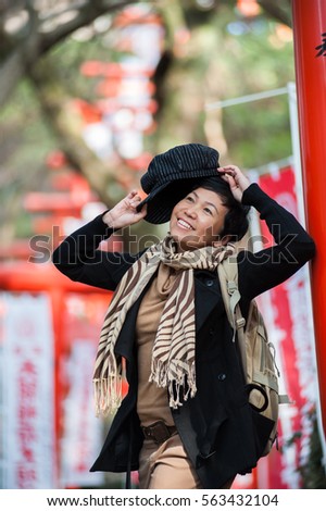 Asian senior female tourist in winter costume traveling in Japan