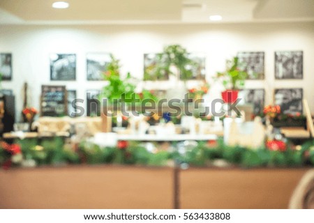 Abstract blur luxury restaurant interior for background. Business meeting. Blurred buffet in Restaurant Cafe. image of wooden table in front of abstract moden decoration. with lot of green plants. 