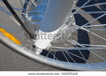 Wheel of the electric bicycle view from above. E bike motor with light reflections. Unfiltered, with natural lighting. 