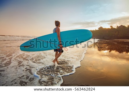 guy surfing on a sunset "instagram" style colors Royalty-Free Stock Photo #563462824