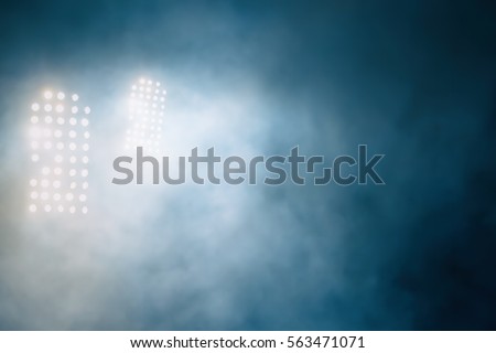 stadium lights and smoke Royalty-Free Stock Photo #563471071