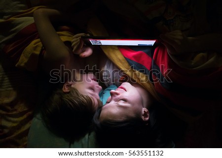 Mother and son playing on tablet