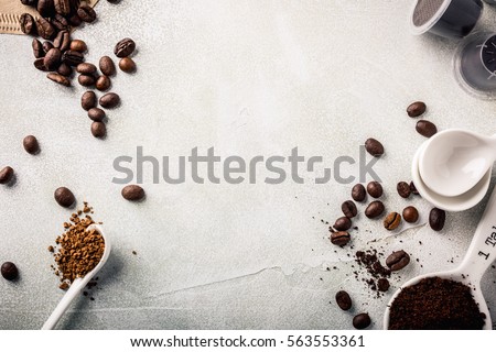 Background with assorted coffee, coffee beans, ground and instant, pads and capsules, retro style toned, copy space, top view. Royalty-Free Stock Photo #563553361