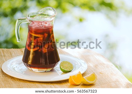 Cool refreshing drink on the background of nature and green trees