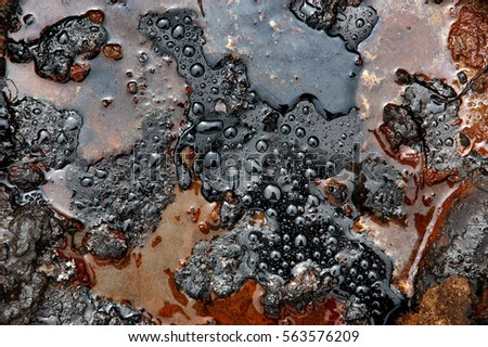A picture of watter drops on the petroleum surface.