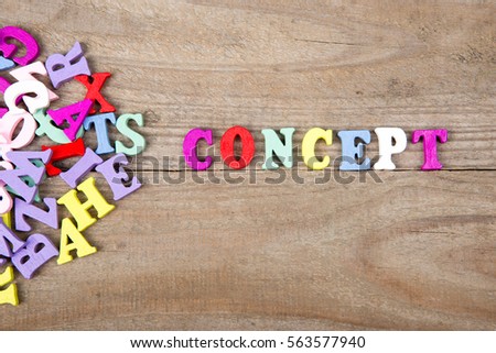 Text "Concept" of colored wooden letters on a wooden background
