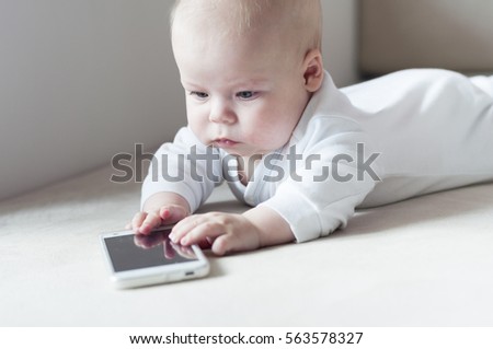 Infant fascinated with cell phone